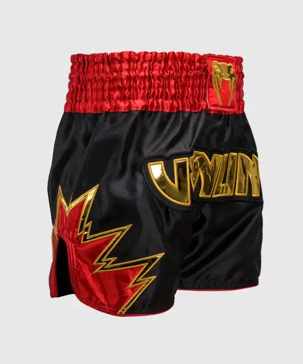 מכנס איגרוף תאילנדי Venum Inferno Muay Thai Shorts - Black/Gold/Red