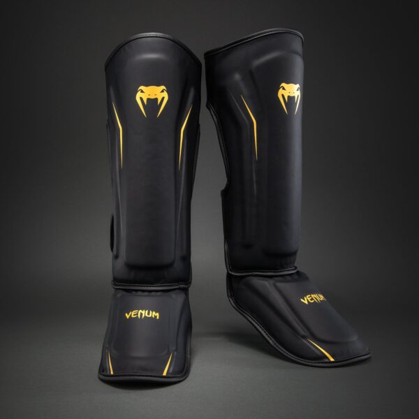 מגני רגליים Venum G-Core Shin Guards בצבע שחור וזהב עם ריפוד מגן לשוק ולכף הרגל